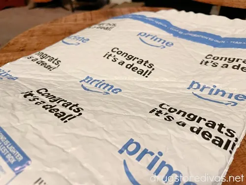 A white Amazon shipping bag with blue and black writing on it.