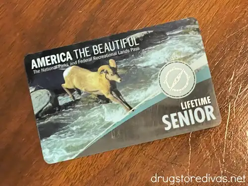 An America the Beautiful lifetime pass for seniors card on a wood surface.