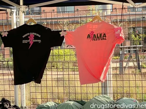 A black and pink shirt hanging up advertising the North Carolina Azalea Festival in Wilmington, North Carolina.