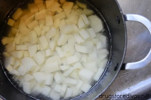 Diced potatoes in a pot of water.