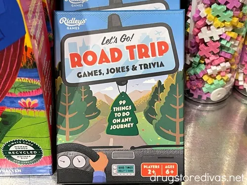 A small book called "Let's Go Road Trip" on a shelf.