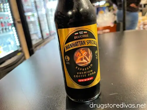 A bottle of Manhattan Special Espresso soda on a table.