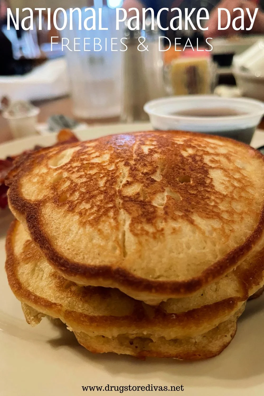Pancakes on a plate with syrup behind it and the words 