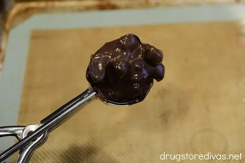 Melted chocolate and peanuts in a cookie scoop.