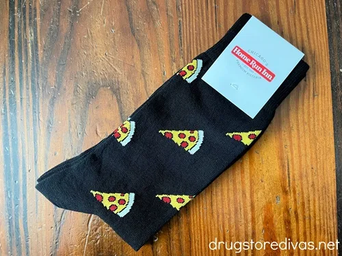 A pair of socks with slices of pepperoni pizza on them.