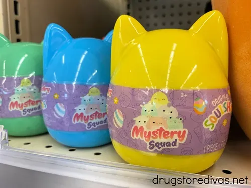 Three Squishmallow blind bag toys on a shelf.