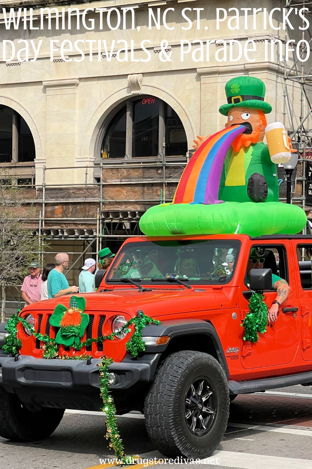 A Jeep decorated for St Patrick's Day with an inflatable leprechaun vomiting a rainbow out the top, driving through a parade, with the words 