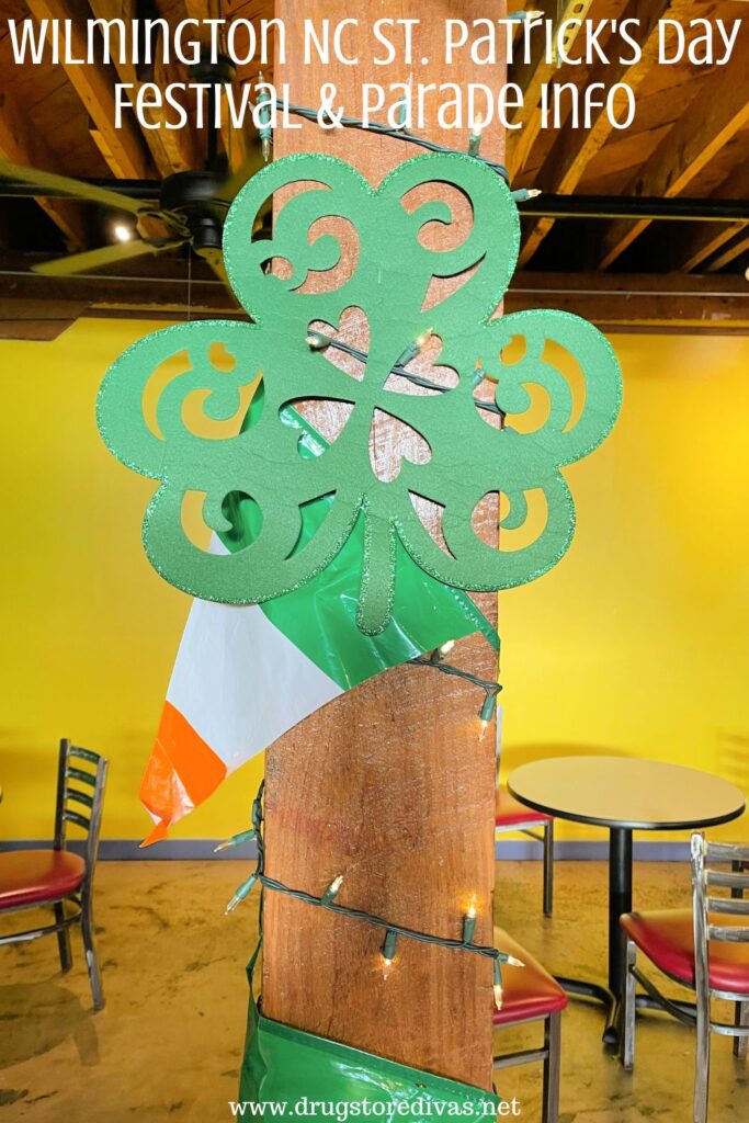 A shamrock on a pole with an Irish flag behind it and the words "Wilmington NC St. Patrick's Day Festival & Parade" digitally written above it.
