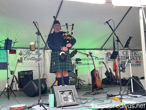A man playing bagpipes on stage at the Cape Fear Hooley in Wilmington, NC.