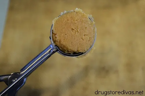 Peanut butter cookie dough in a cookie scoop.