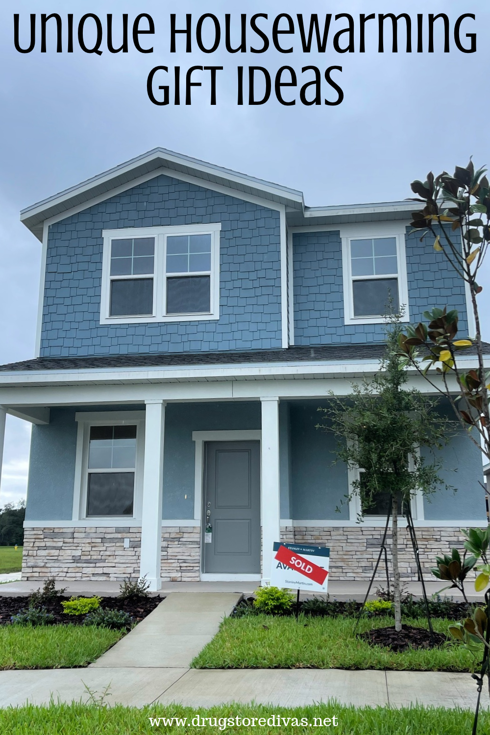 A home with a SOLD sign in front with the words 