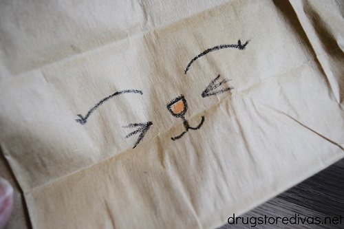 A bunny face drawn on a paper bag.