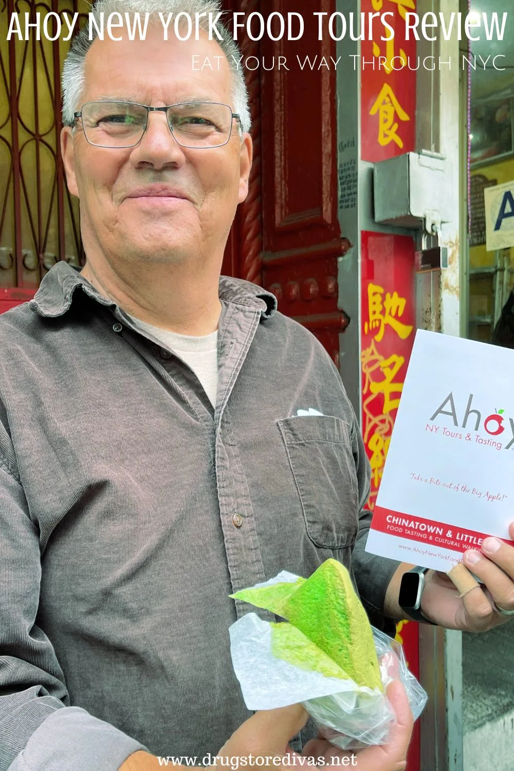 A man holding a green pastry and a guide book with the words 