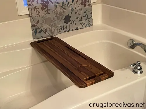 A bathtub with a bathtub tray over it.