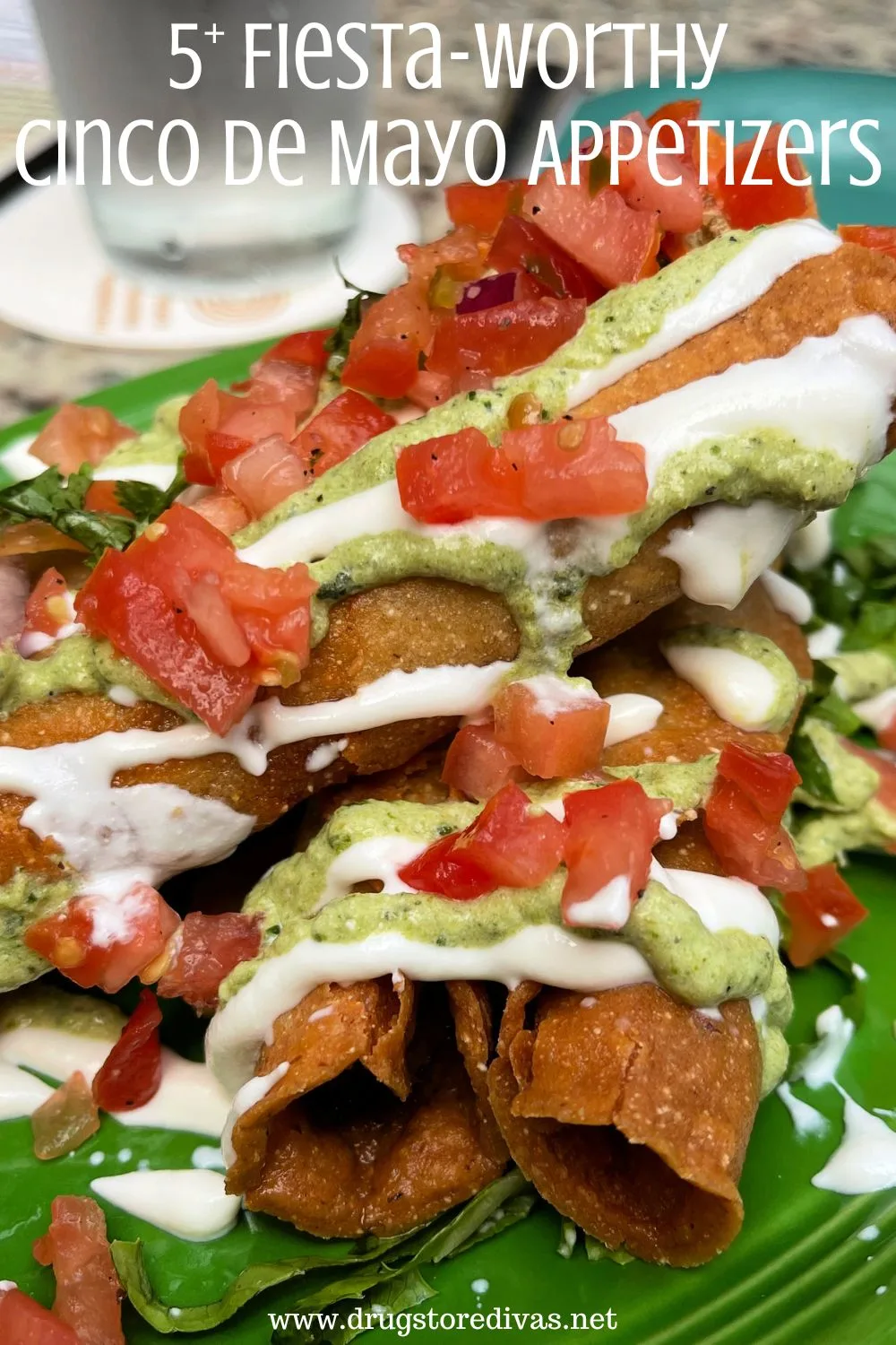 Flautas topped with tomatoes, lime crema, and cream with the words 