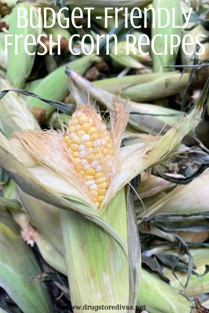 A partially shucked ear of corn with the words "Budget-Friendly Fresh Corn Recipes" digitally written on top.