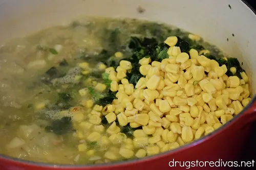 Soup, spinach, and corn in a Dutch oven.