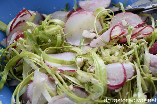 Shaved Asparagus And Radish Salad in a blue bowl.