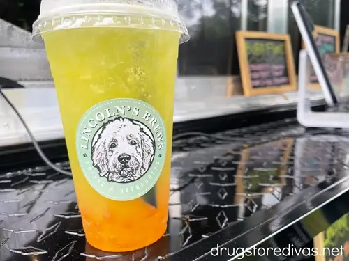 An orange and yellow boba tea on a food truck ledge at the Sumter Iris Festival.