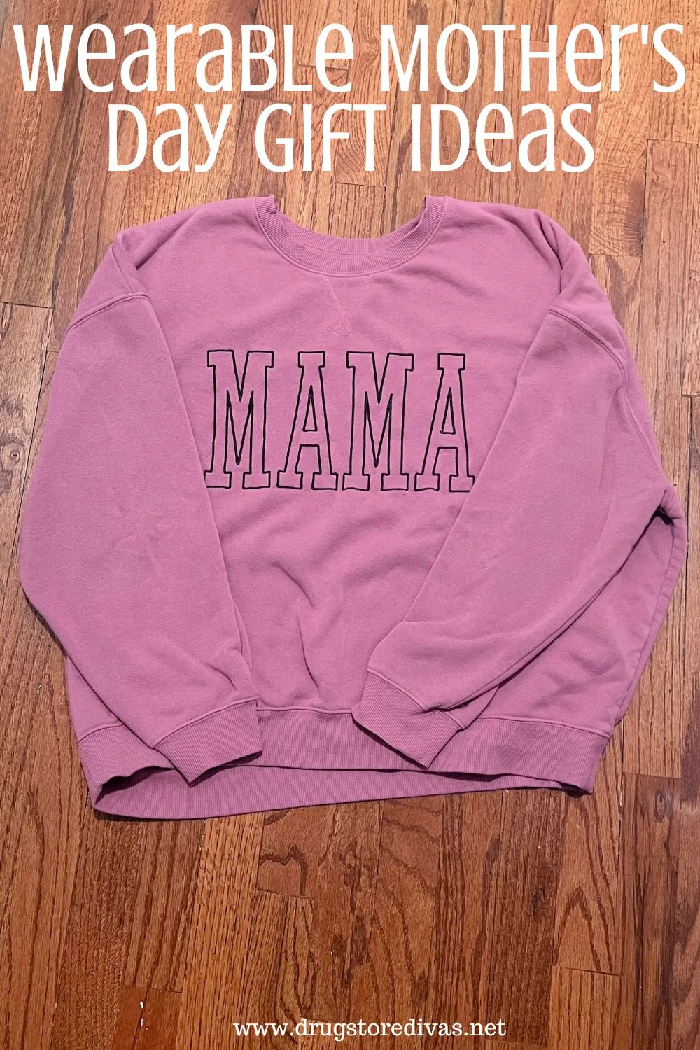 A purple sweatshirt with the word MAMA on it on a wooden floor and the words 