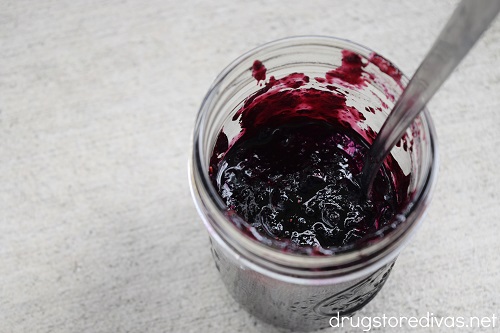 A mason jar filled with homemade blueberry jam.