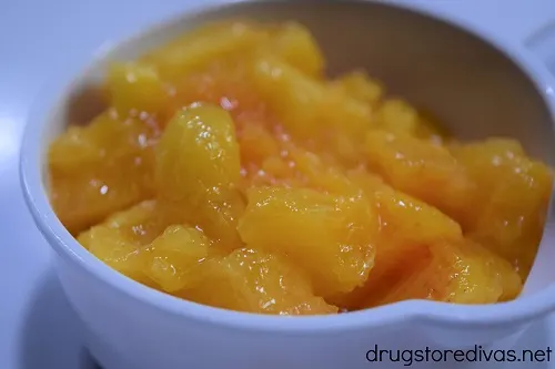 Chopped peaches in a measuring cup.