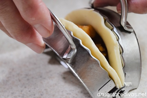 A dumpling maker being closed with a pie inside.