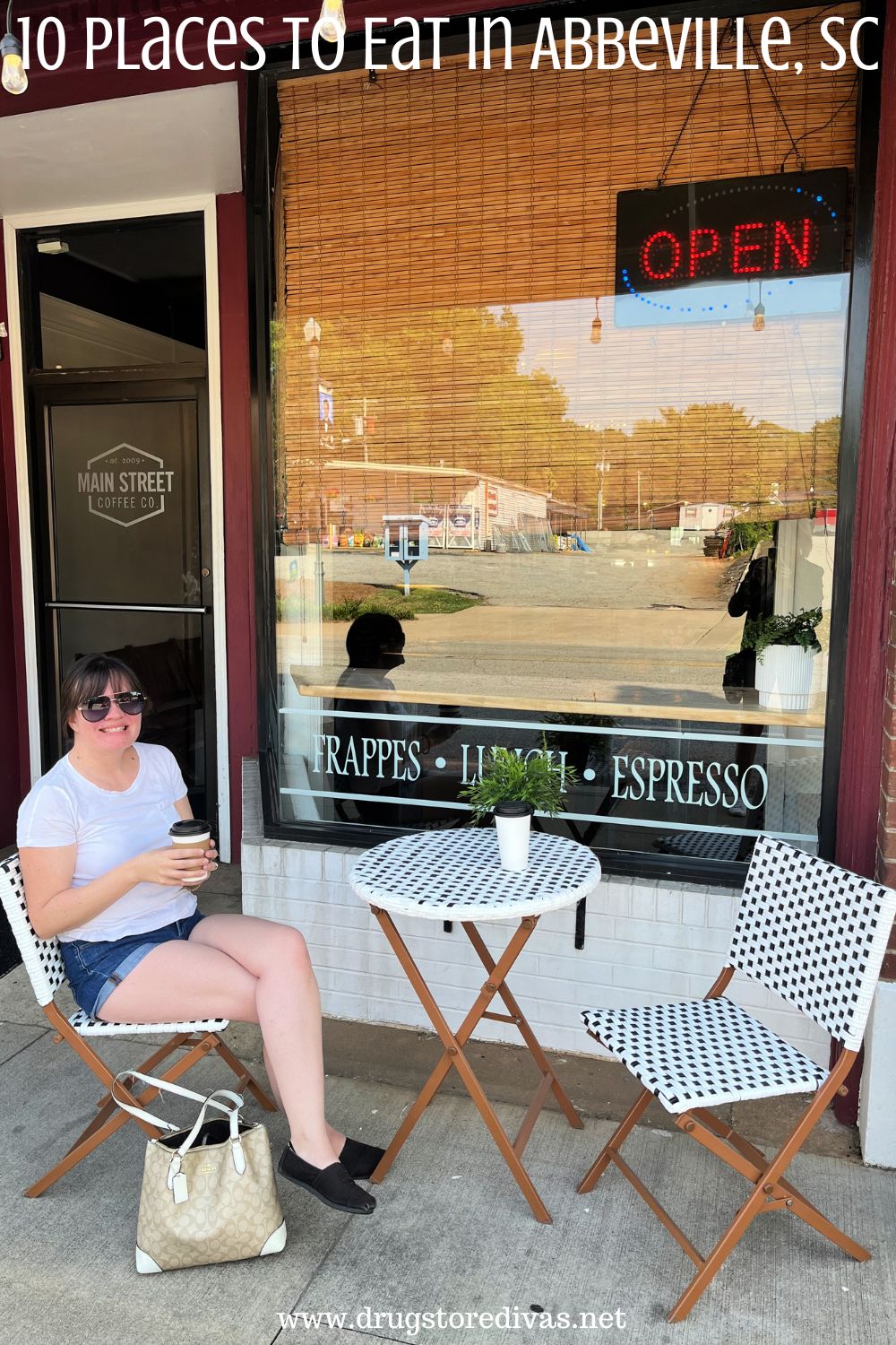 A woman with coffee at a table outside a coffee shop with the words 