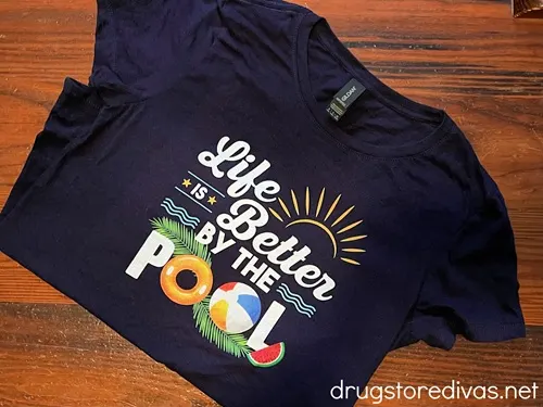 A dark shirt that says "Life is Better by the Pool" on it.
