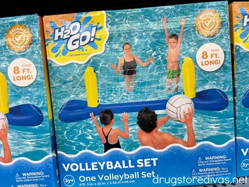 A box with a pool volleyball game on a shelf.