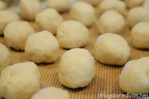 Dough balls on a silicone baking mat.