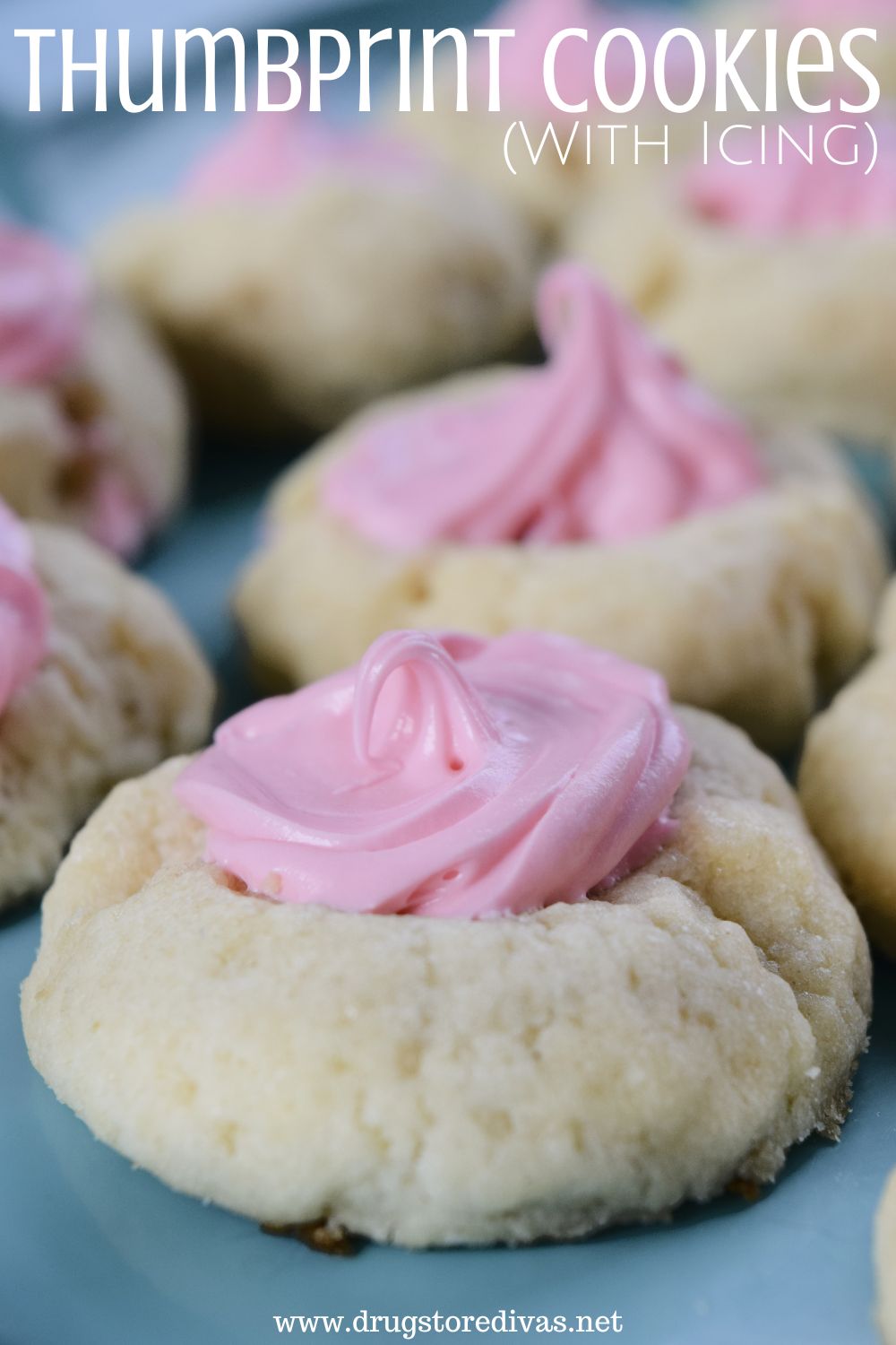 Small sugar cookies with pink frosting in the center and the words 
