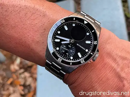 A silver watch with a black face made by Withings.