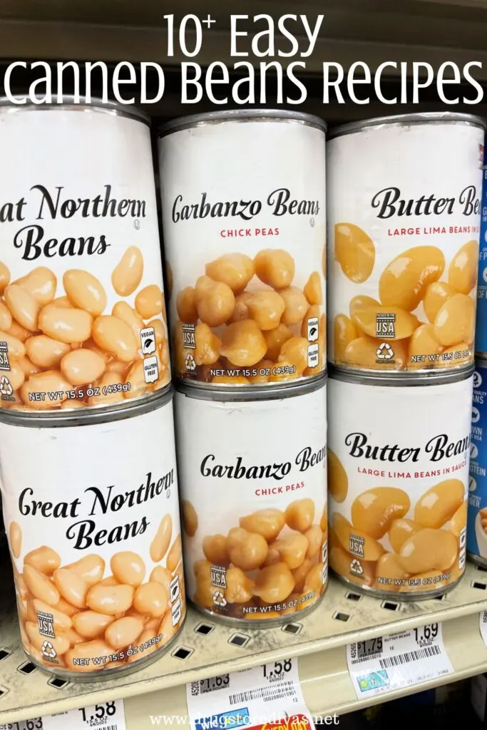 Six cans of beans on the shelf in a store with the words "10+ Easy Canned Bean Recipes" digitally written above them.