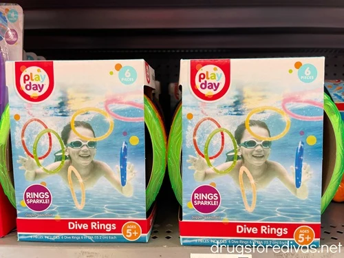 Two unopened packs of dive rings on a shelf in the store.