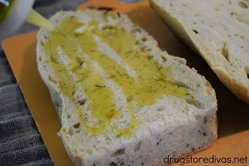 Half a loaf of bread with olive oil on it.
