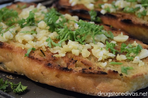 Parsley and chopped garlic on top of bread.