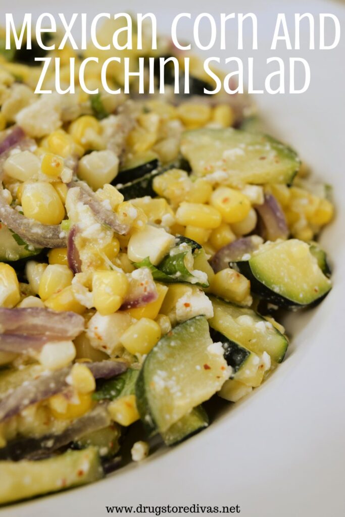 Corn, zucchini, red onion, and white cheese mixed in a bowl with the words "Mexican Corn And Zucchini Salad" digitally written on top.