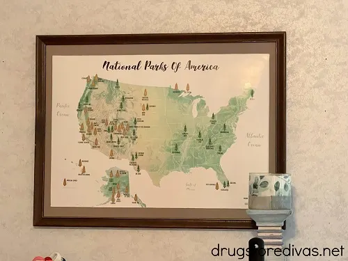 A National Park Scratch Off Map in a frame on a wall.