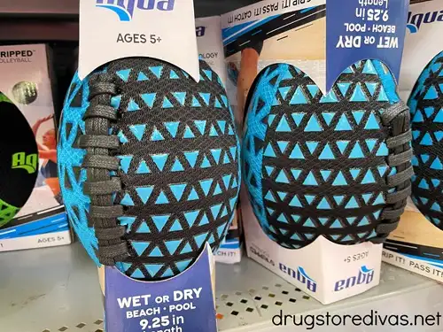A blue and black pool football on a store shelf.