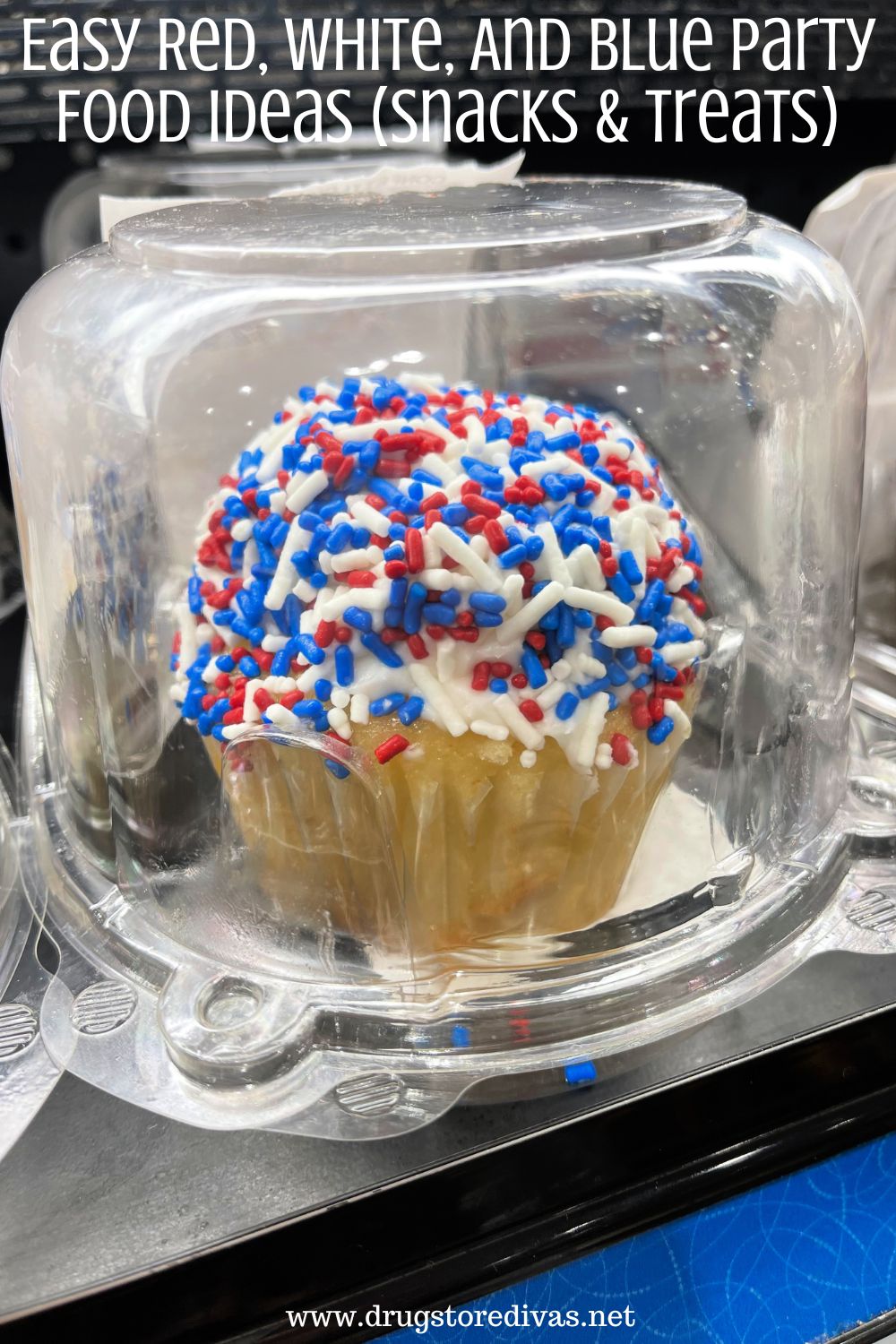 A cupcake with red, white, and blue sprinkles in a plastic container and the words 