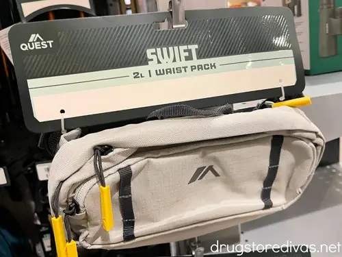 A waist pack in its package on a hang pin in a store.