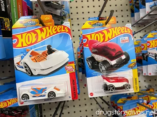 Hot Wheels cars in a package on a peg.