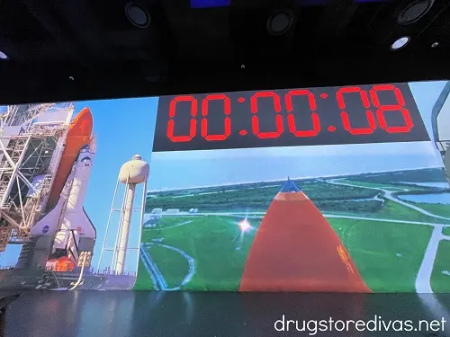A rocket launch projected on screens with the countdown at 00:00:08 at the Illumarium Las Vegas.