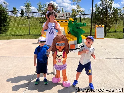 Four boys posing with a LEGO display at LEGOLAND.