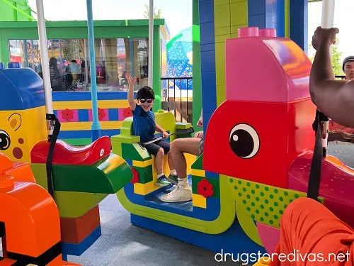 A boy riding the Duplo carousel in LEGOLAND.