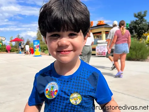 A boy wearing a happy birthday pin at LEGOLAND.