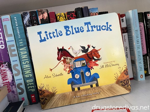 The Little Blue Truck board book on a shelf.