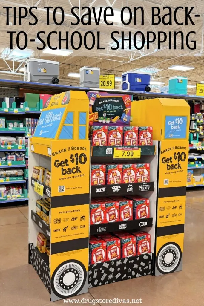 A school bus-shaped display in a grocery store with the words "Tips To Save On Back-To-School Shopping" digitally written on top.