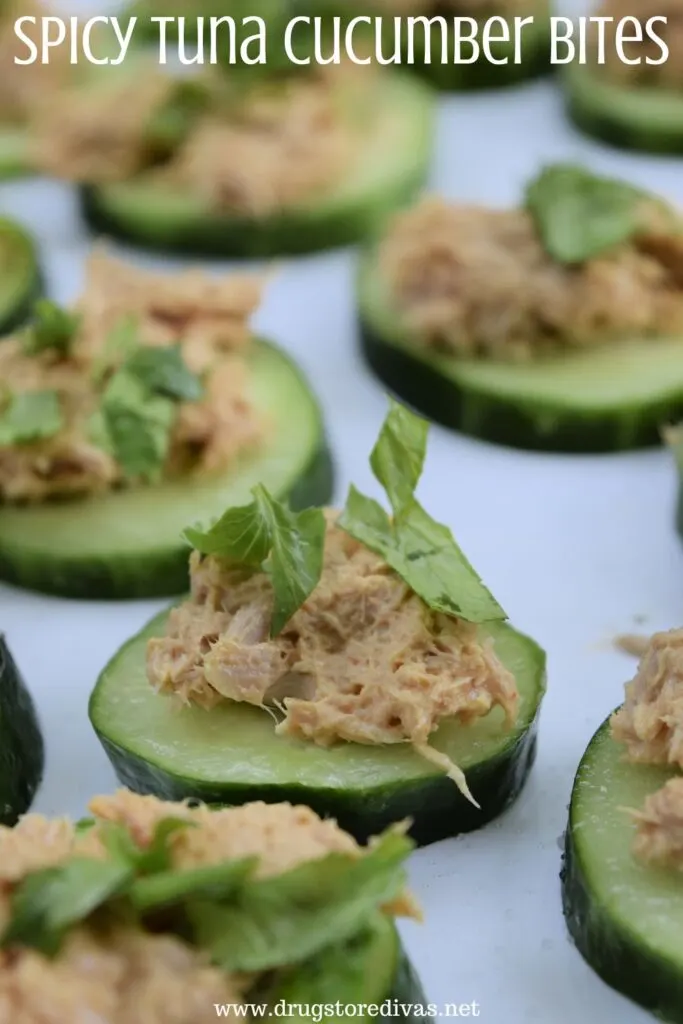 Cucumber with tuna and cilantro on them and the words "Spicy Tuna Cucumber Bites" digitally written on top.